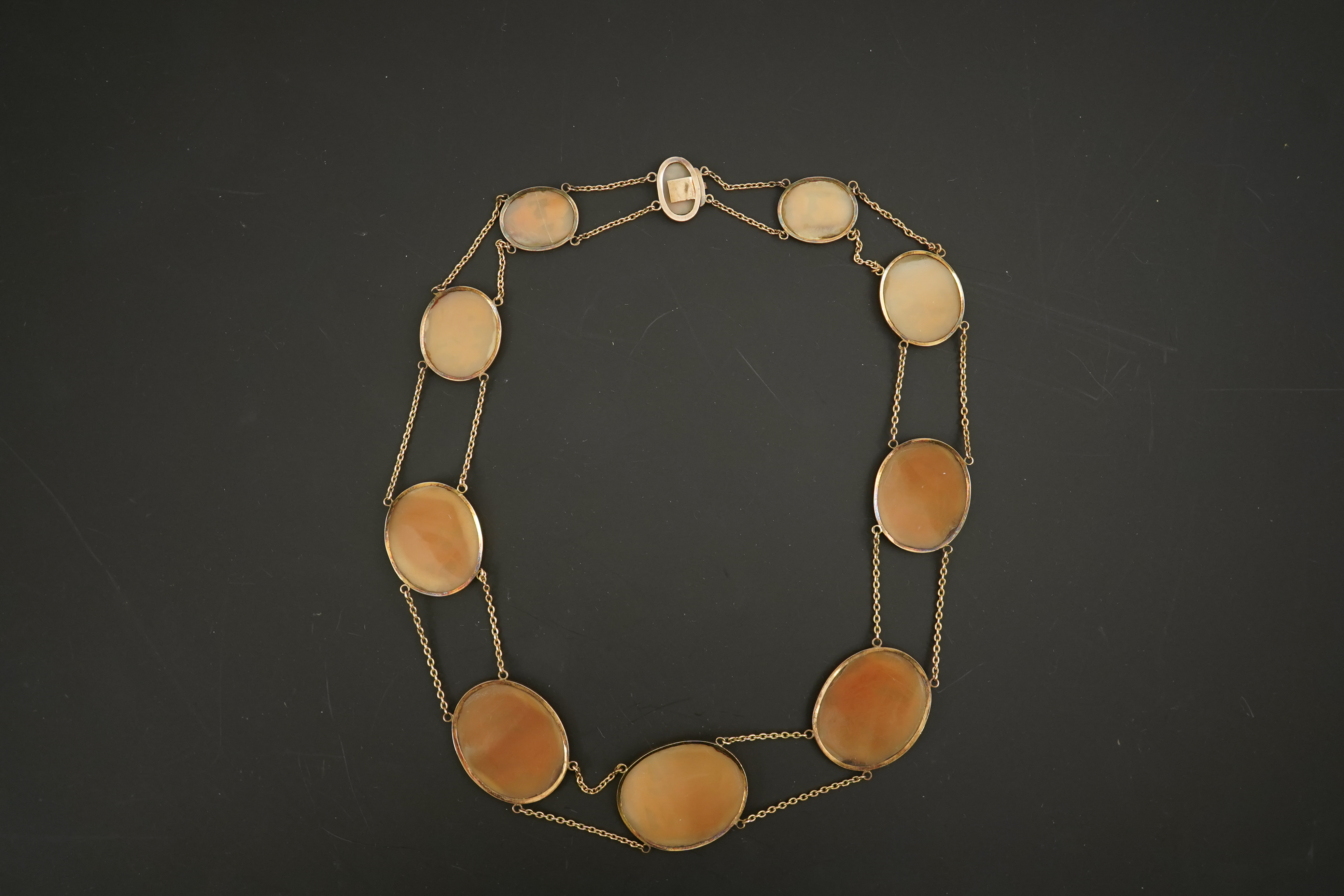 An early 19th century Italian Grand Tour gold double chain link and ten graduated oval cameo shell set necklace